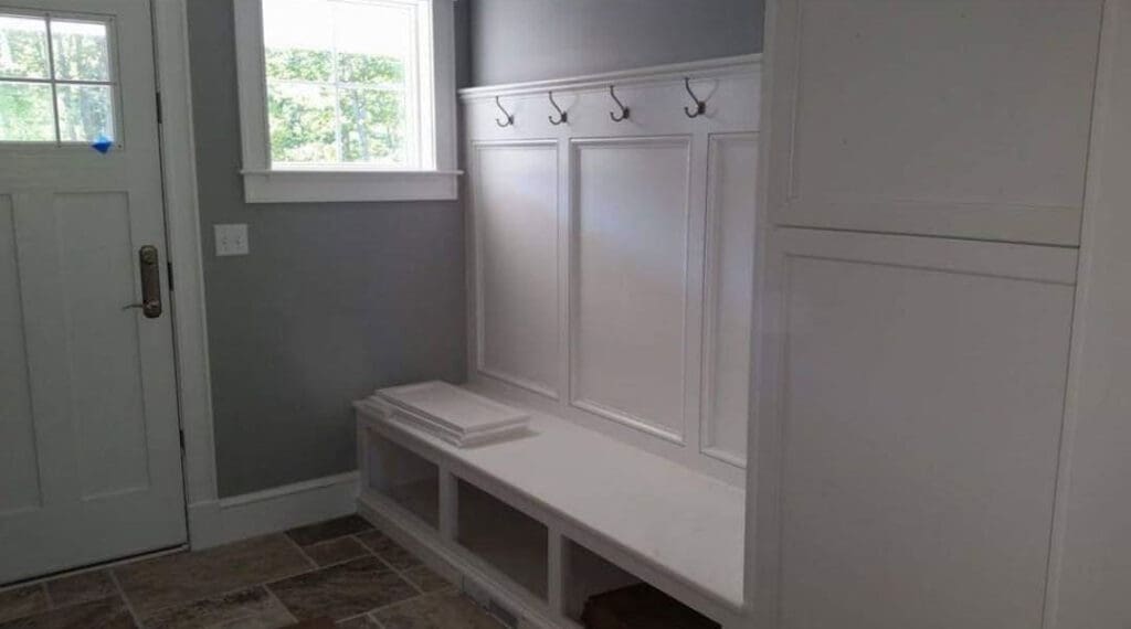 a custom woodwork bench in an entry way built by GWC builders